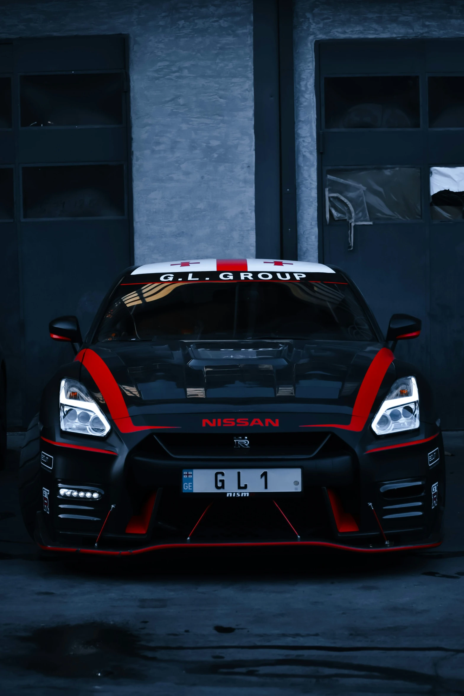 the rear end of a racing car in a garage