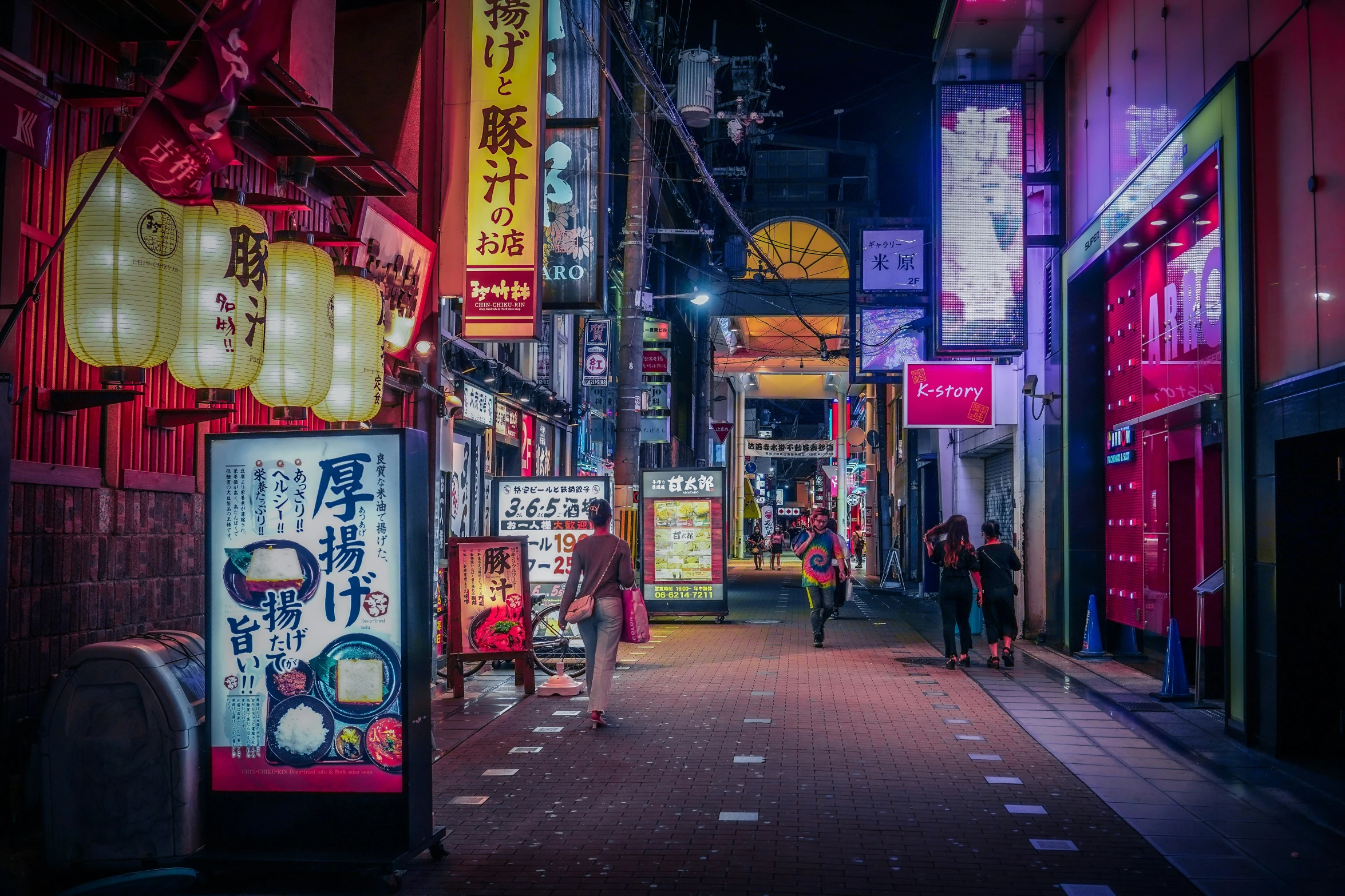 neon signs light up the street at night