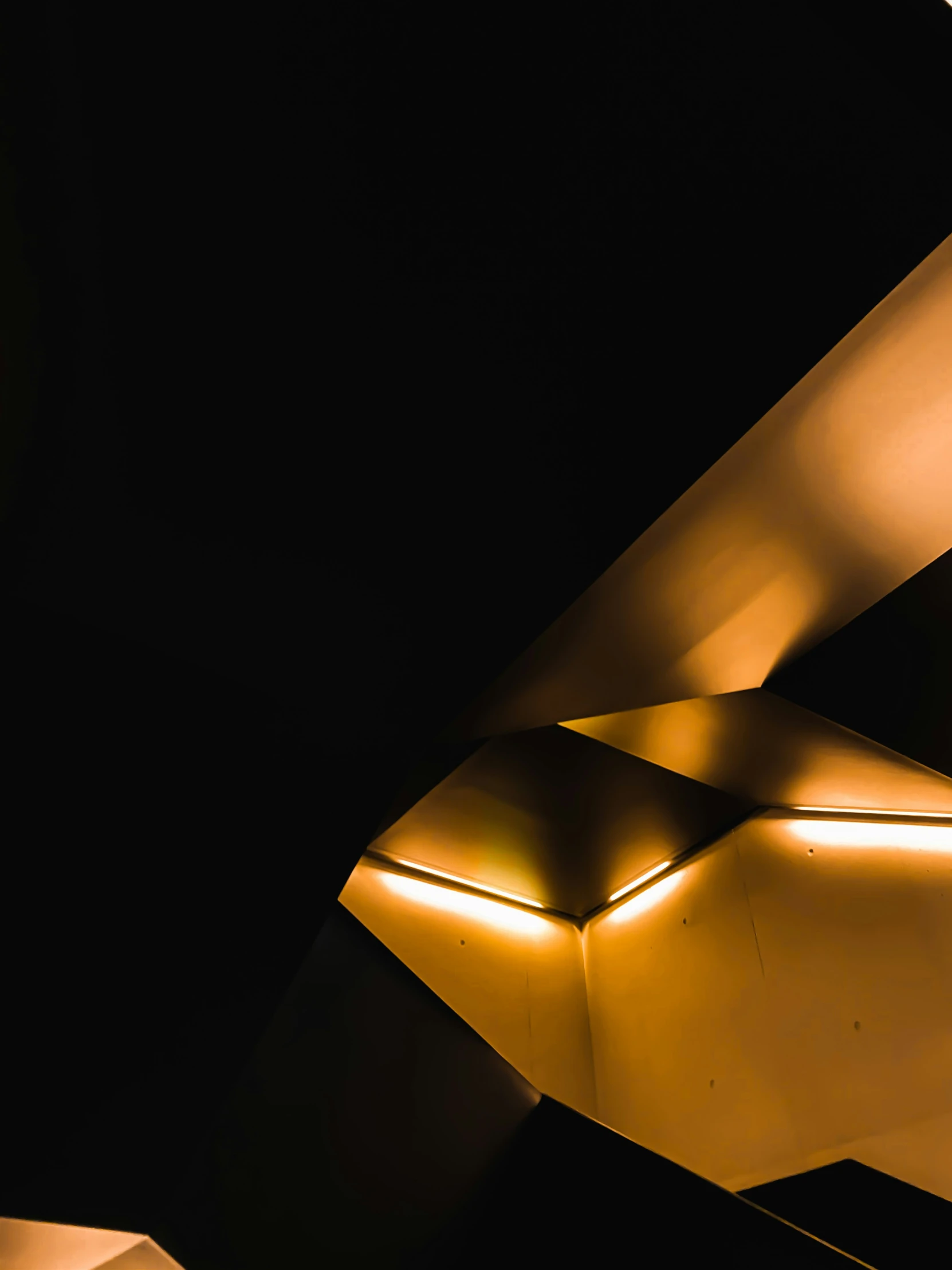 a building with a black background and golden lighting