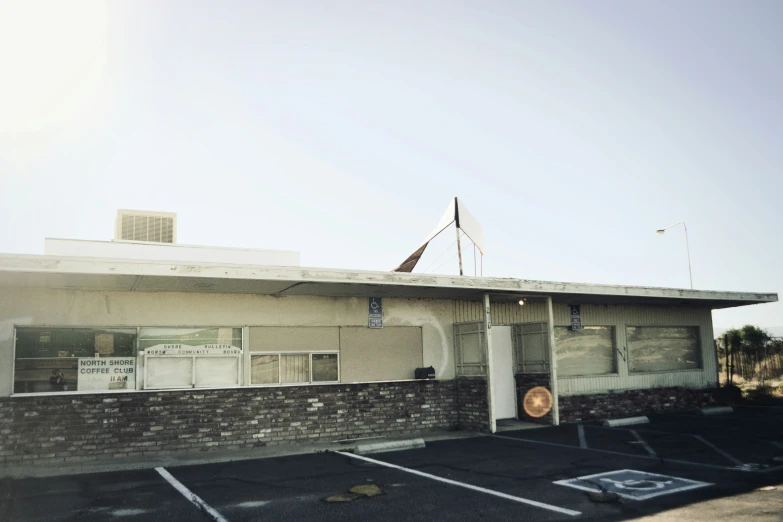 an old parking lot with a building in the background