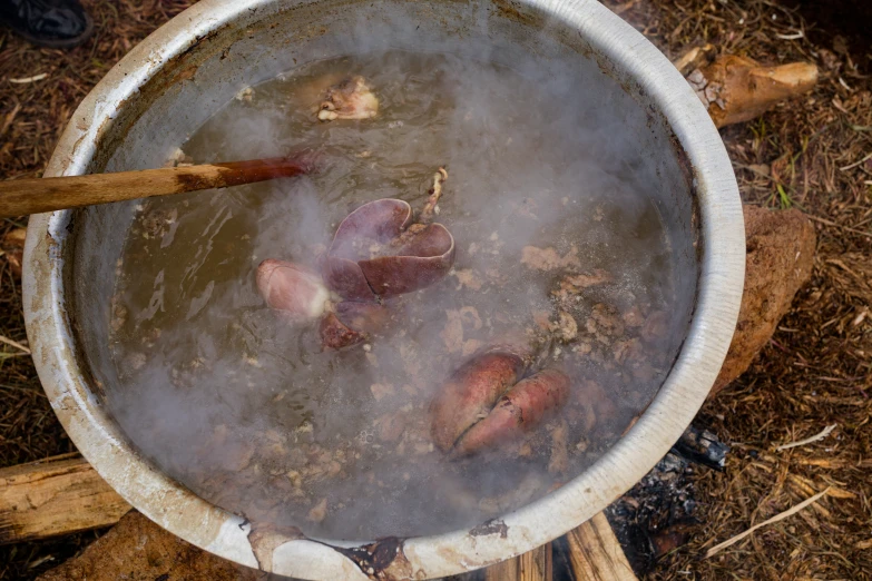 a pot filled with some soup with a ladle