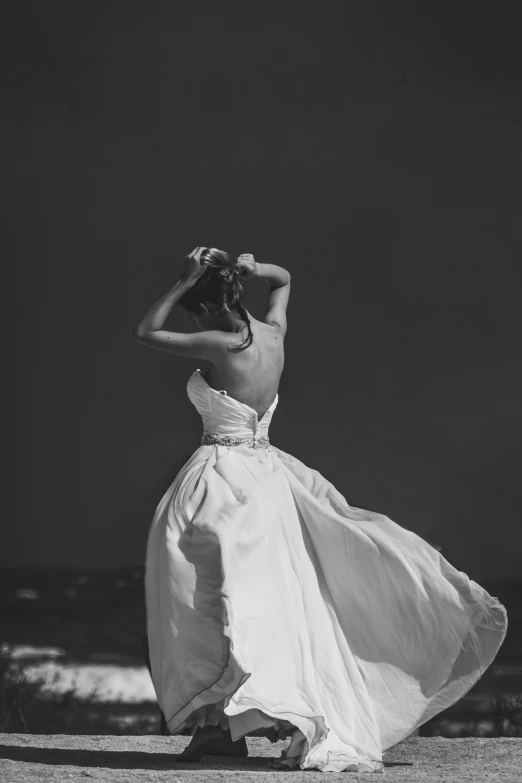 a woman is wearing a white dress on the beach
