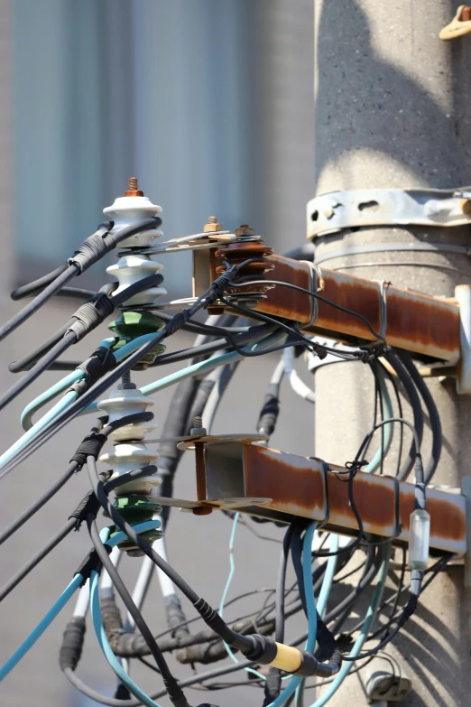 a group of wires and cords attached to a pole