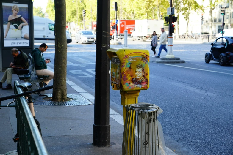 a very colorful machine sitting on the side of a road