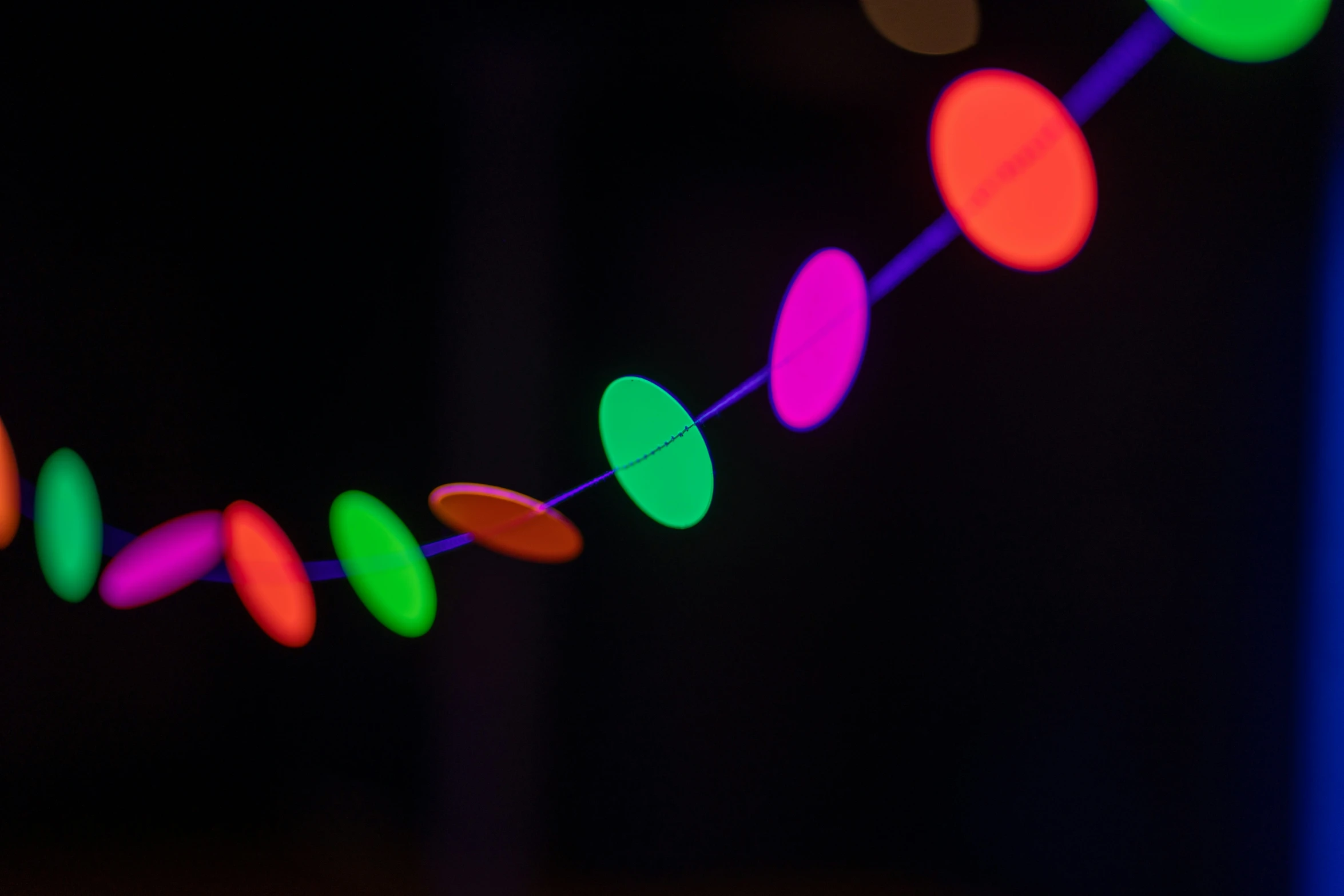 string lights against black background lit up by colored leds