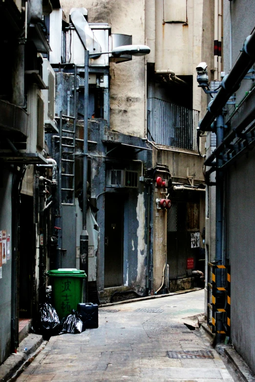 the trash can is beside the large building