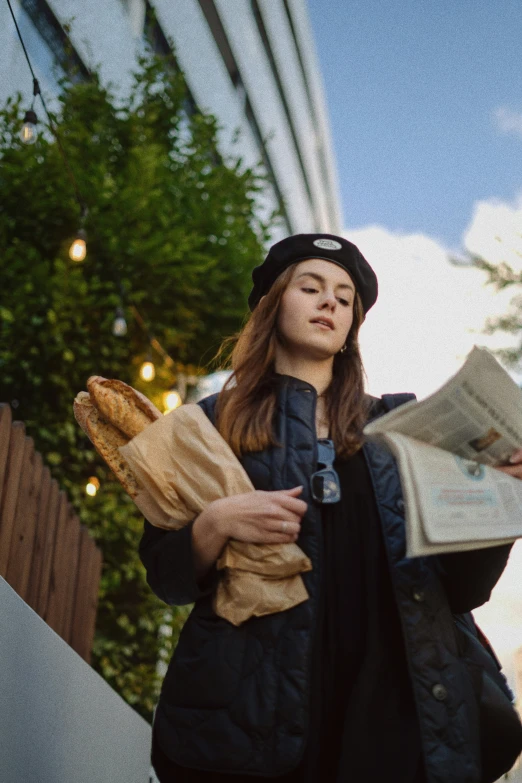 a woman in black jacket holding bread