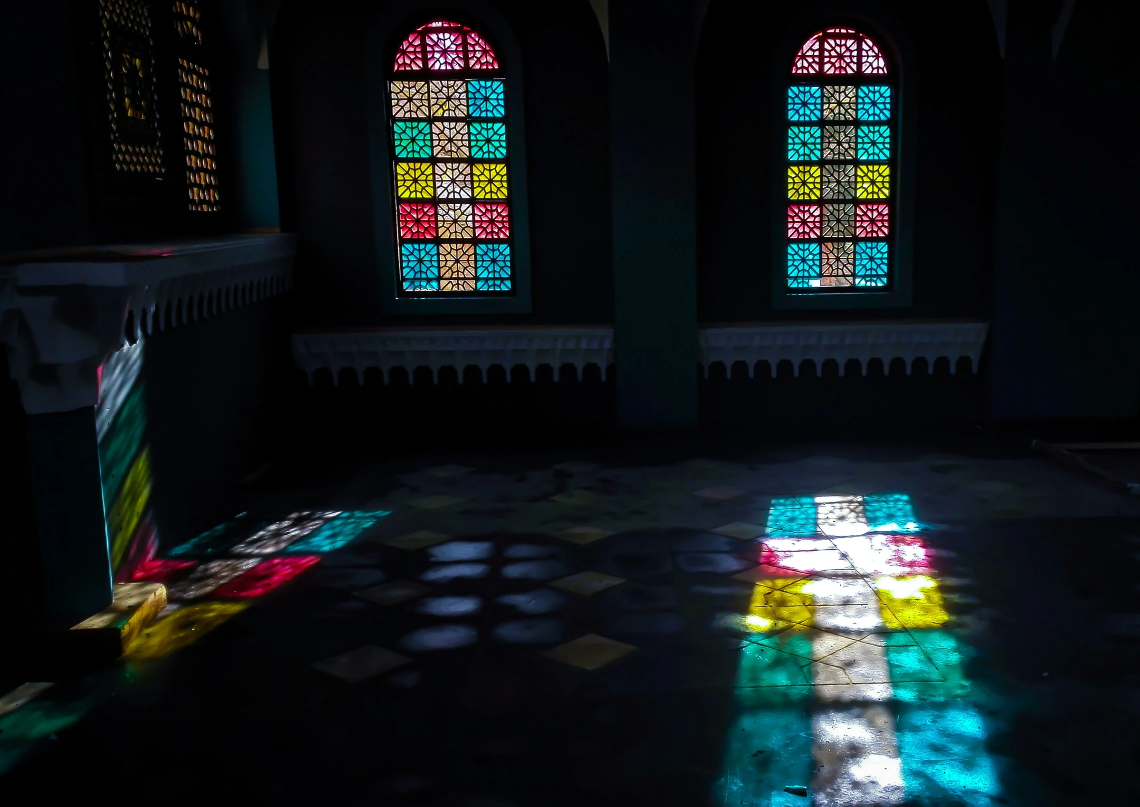 sunlight shines through stain glass in the cathedral