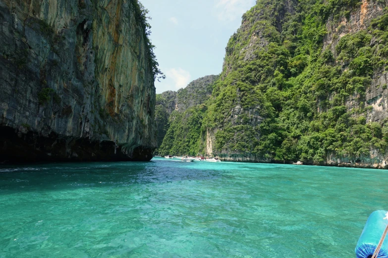 there are many large rocks and mountains above the water