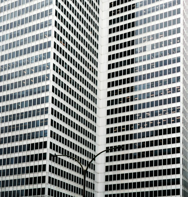 an image of a clock mounted to the side of a tall building