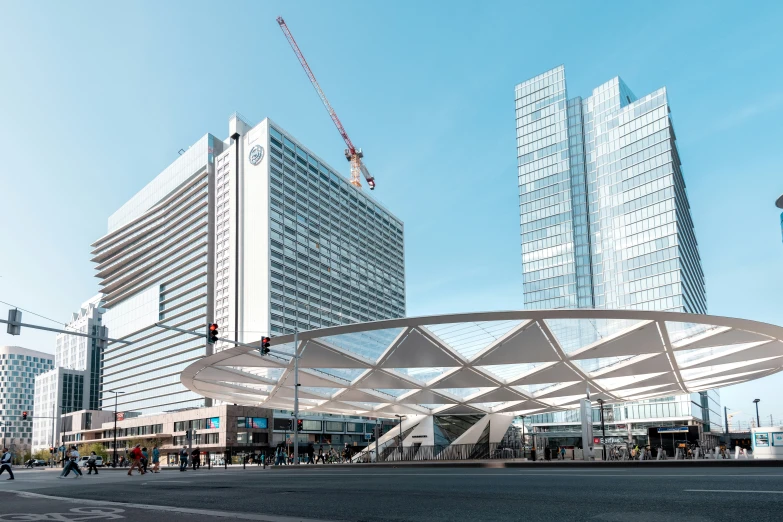 a white bridge sits in front of two large skyscrs