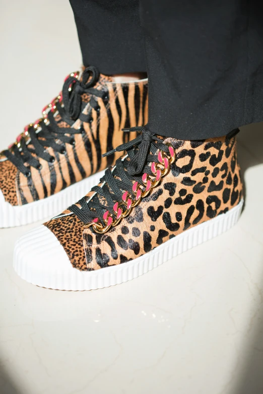 a person with leopard print shoes and sneakers
