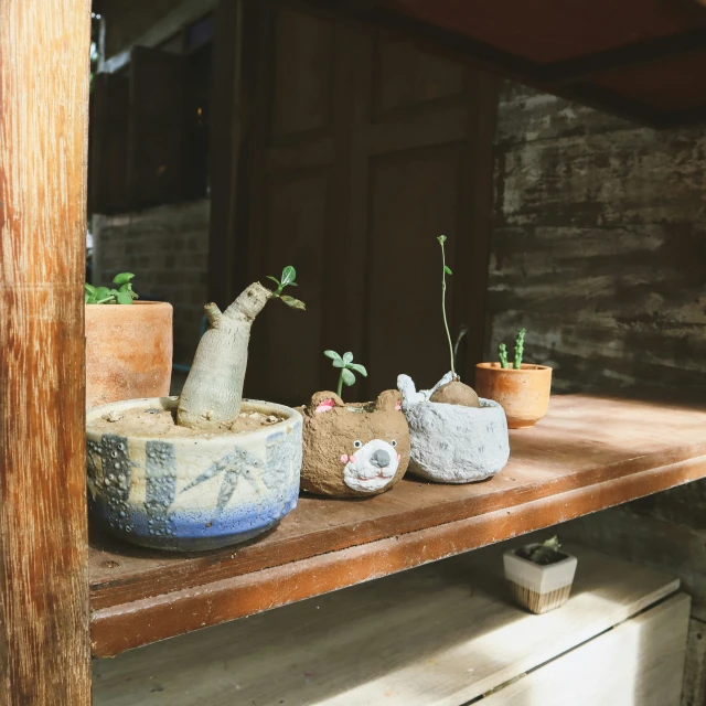 a couple of cement animal sculptures on top of a shelf