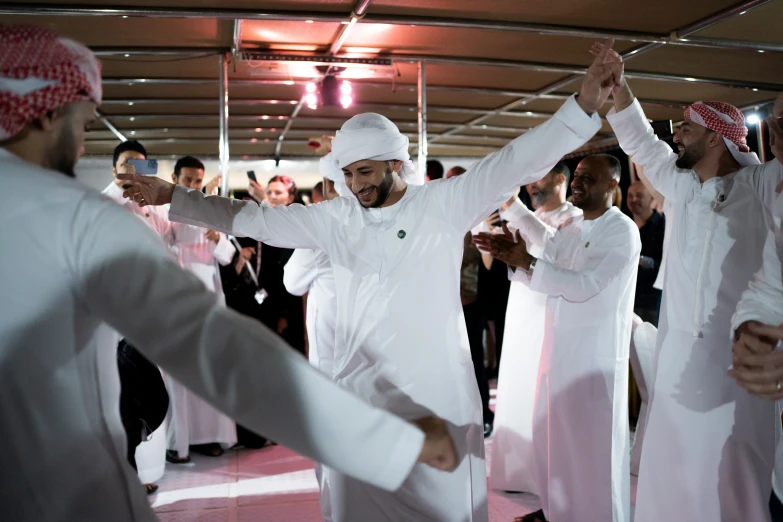 two men in white doing a dance together