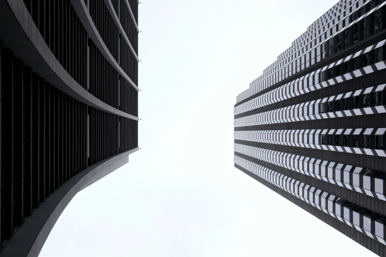 looking up at two tall buildings in the city