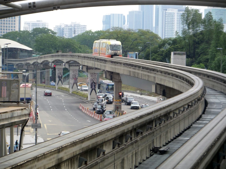 a city street is pictured with a bus passing underneath it