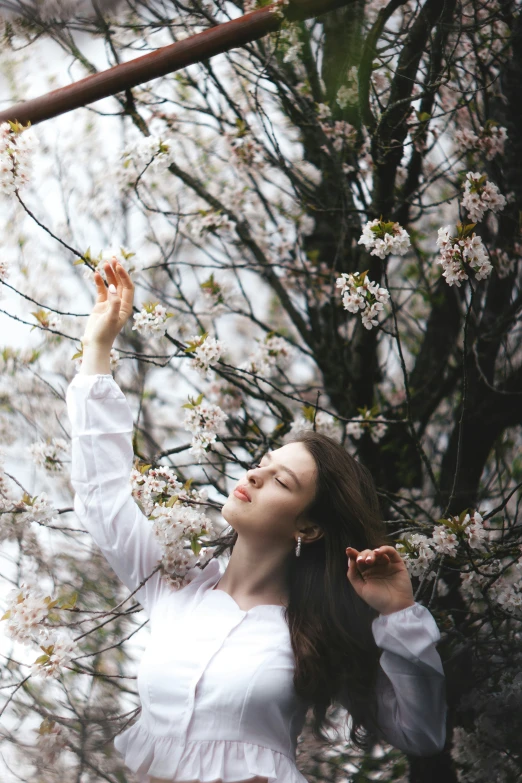 a woman in white dress by some flowers