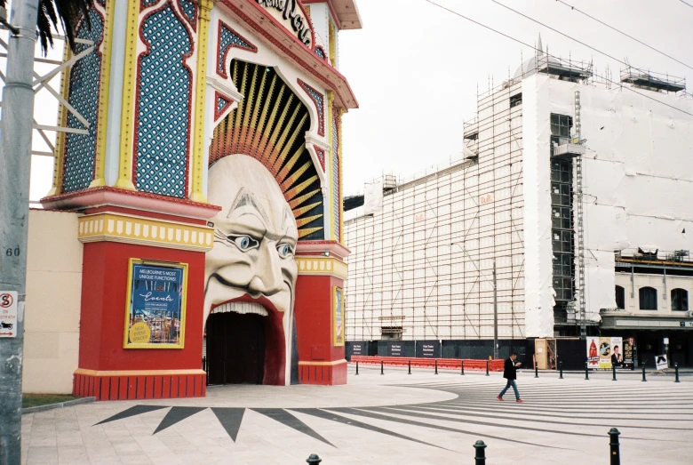 the entrance to the building with a giant clock in front