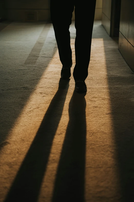 a person is walking down the hall of an empty building