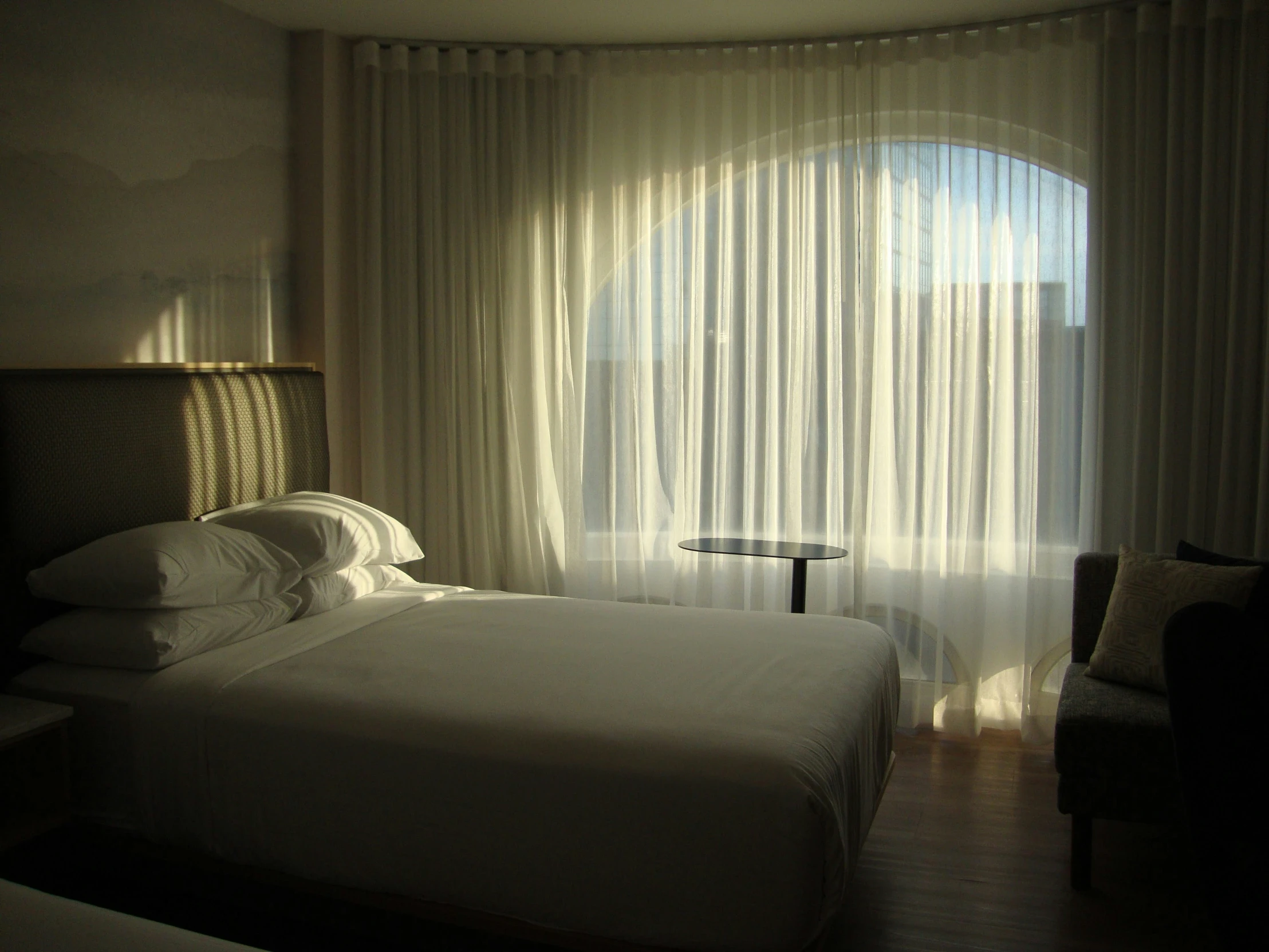 a bedroom with curtains and a bed