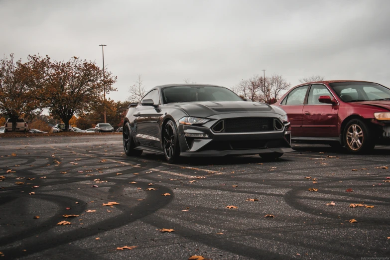 two cars parked on a parking lot near each other