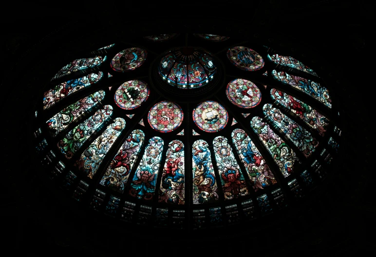 a large circular stained glass window with clock design on it