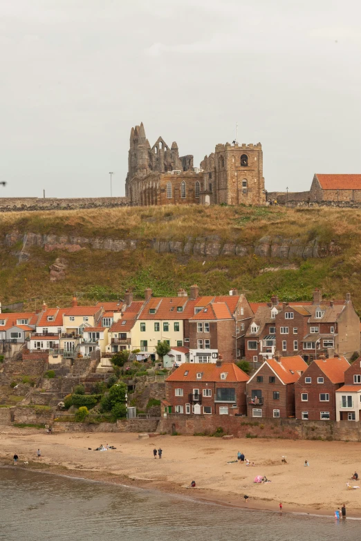 houses by the edge of the water next to a cliff