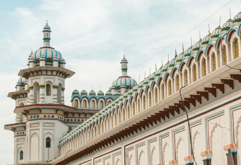 a tall building with ornate blue, white and red dome tops