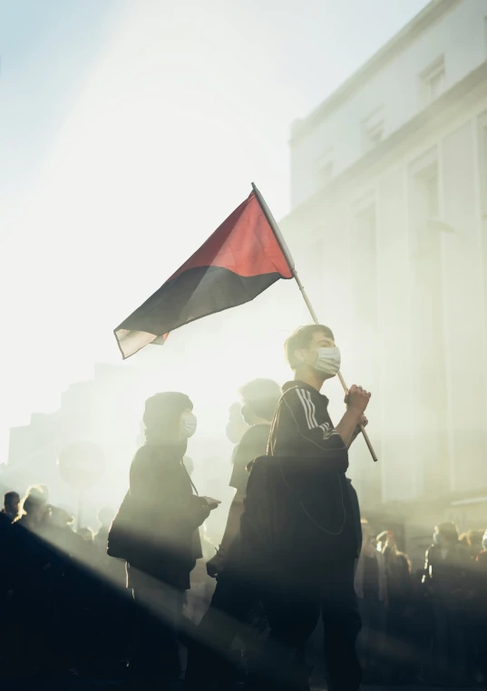 people with their heads turned are holding flags