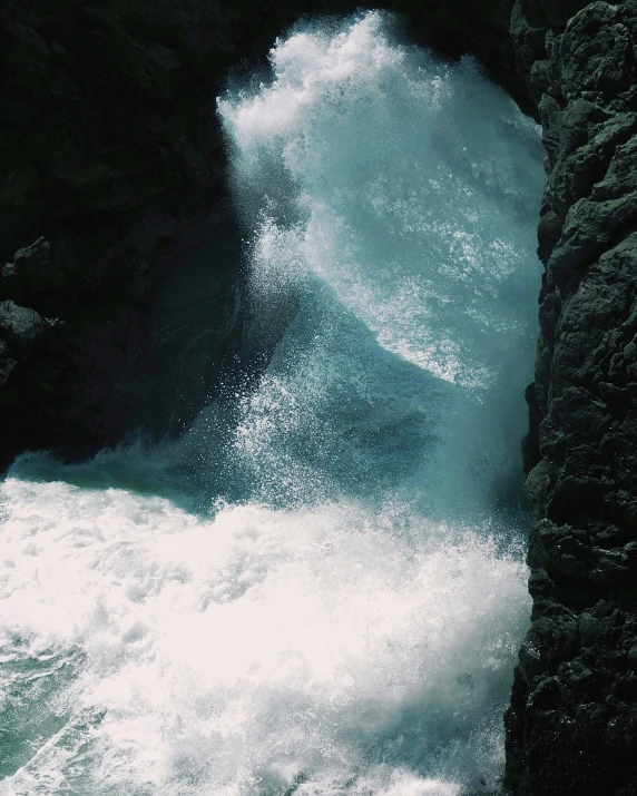 white water rafters float under turbulent rocks