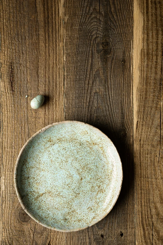 a blue bowl on top of a wooden table