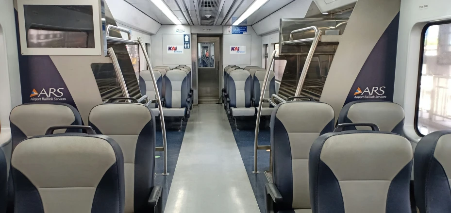 seats sitting in the back of a train on a subway