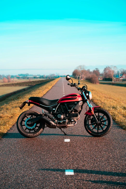 a red motorcycle parked on the side of the road