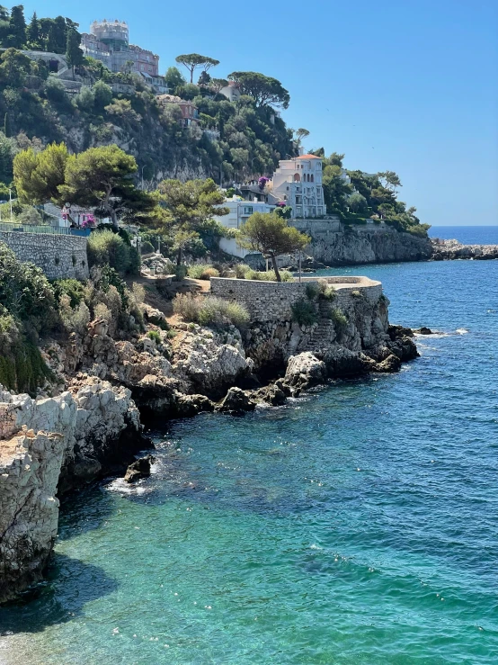 a rocky coastline stretches toward a town on a cliff