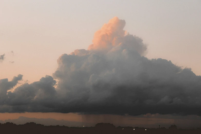 an airplane is flying near a very large cloud