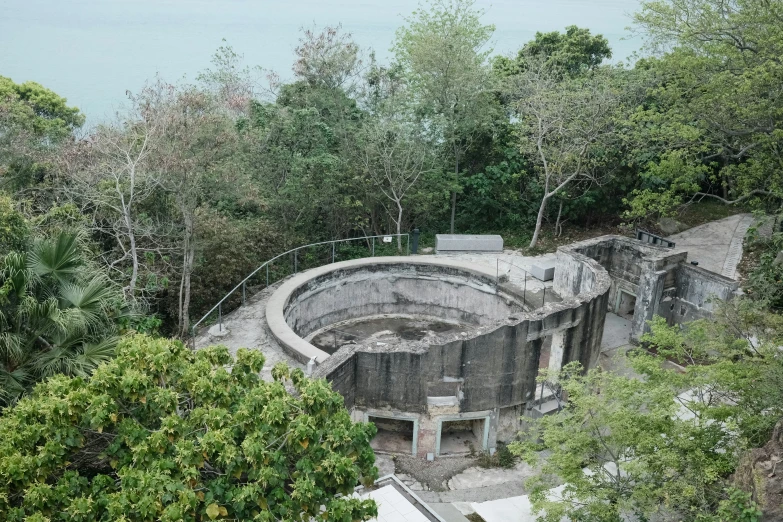 an old quarry with water and trees in the background