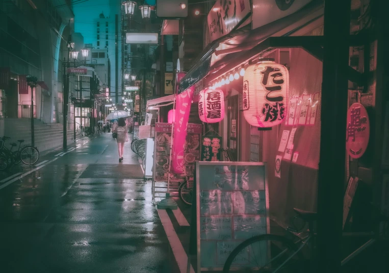people walking down the street at night in an asian city