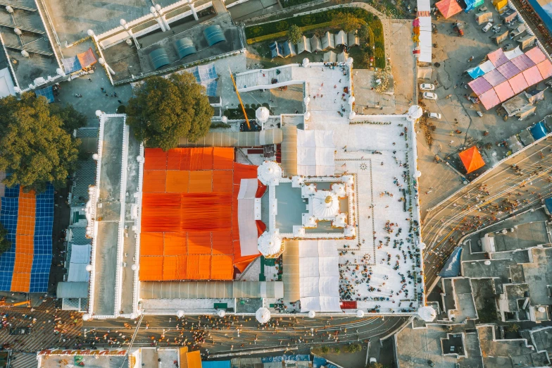 the aerial view of a school and a few buildings with orange roofs