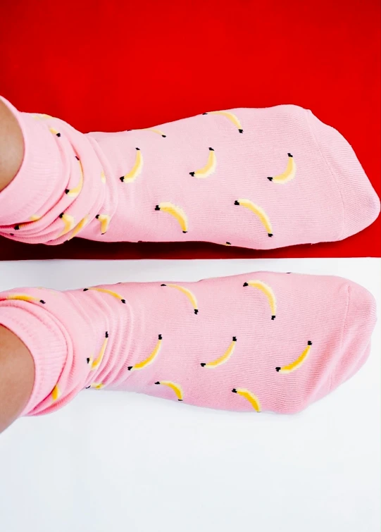 someone has their feet up and wearing banana socks