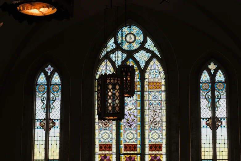 a light shines from a stain glass window