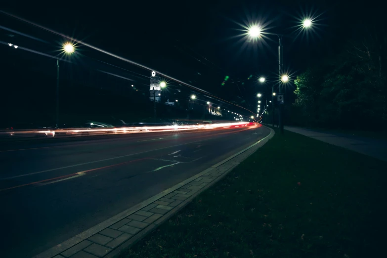 a empty city street with car trails in the distance