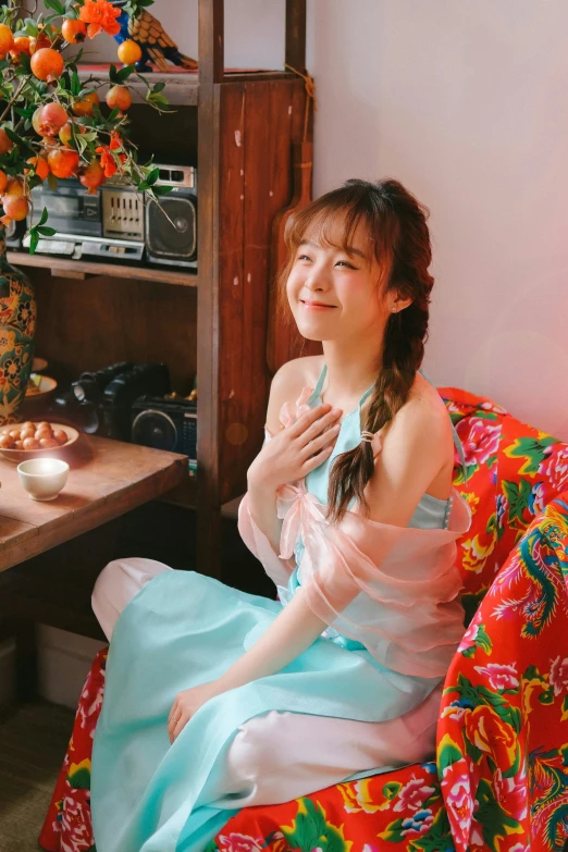 a beautiful young woman sitting on top of a colorful chair