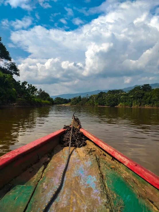 a person rowing on a river in a boat