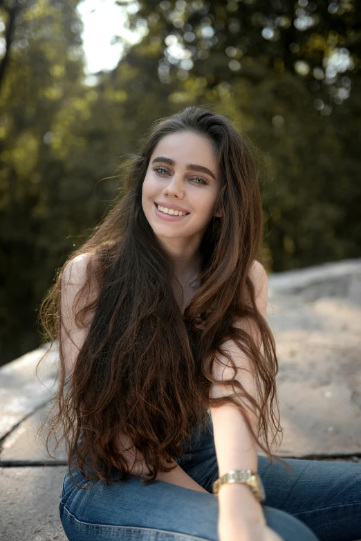 a woman sitting down and posing for a po