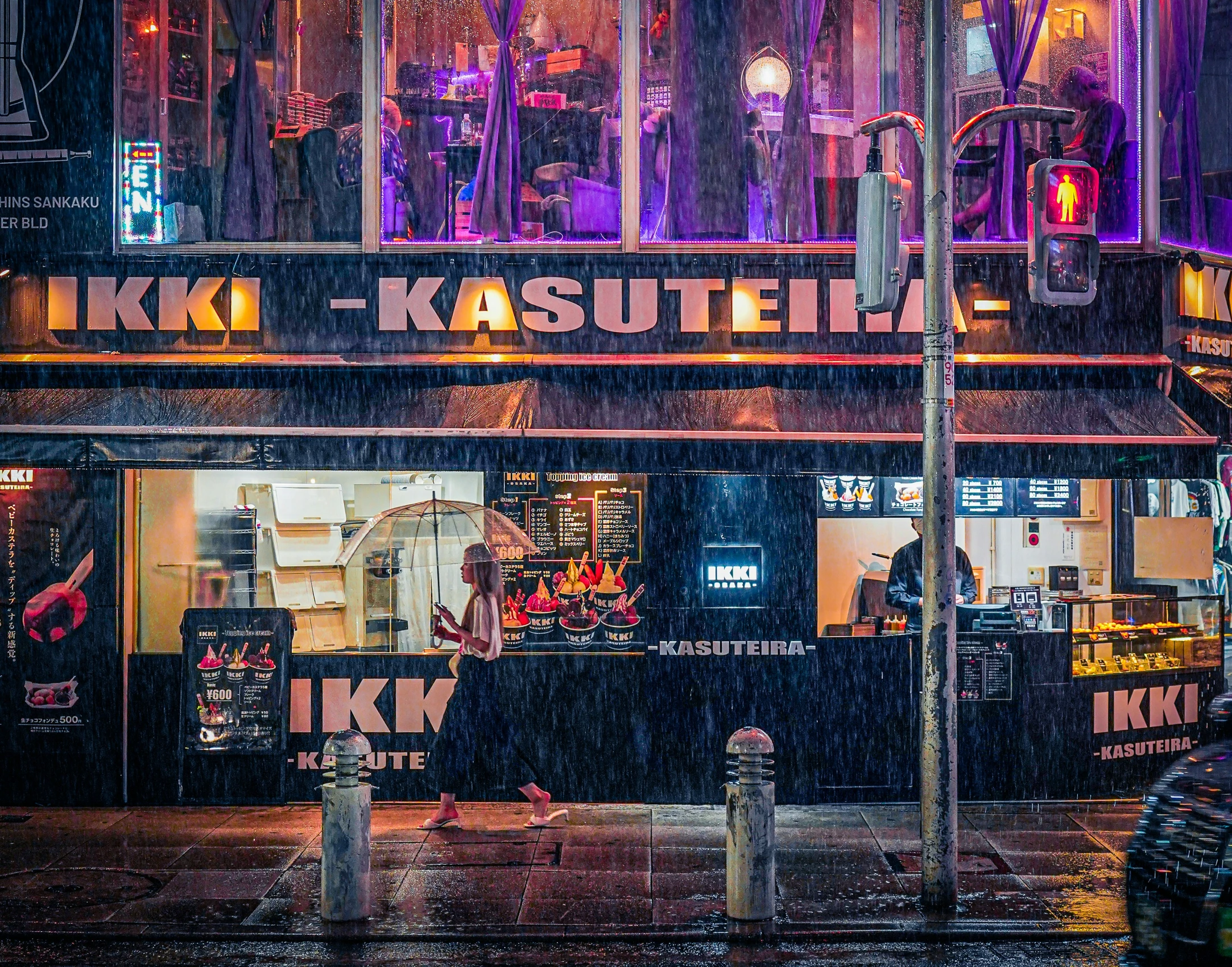 a building that has a bunch of people standing outside in the rain