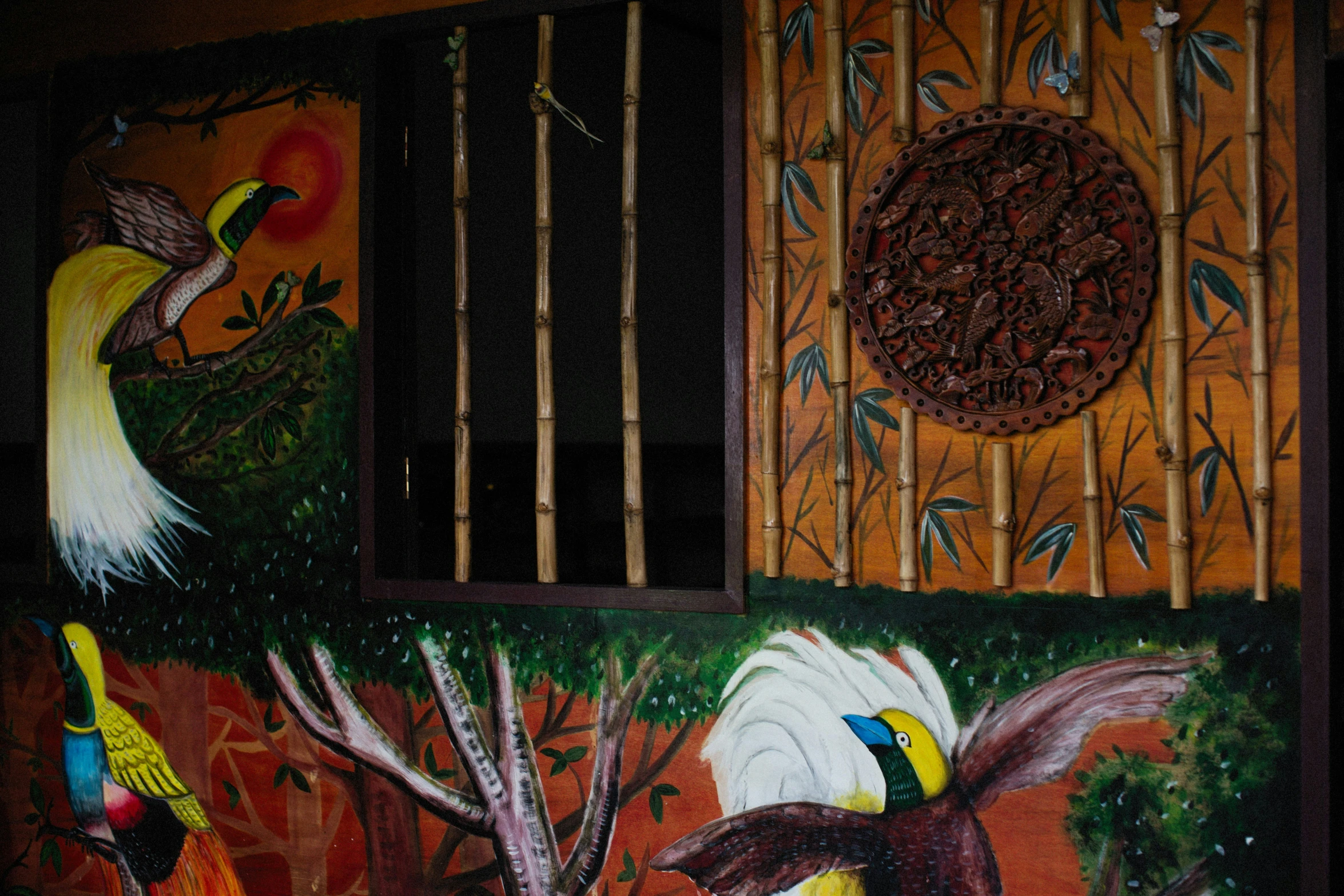 a painting with birds on the wall of a home