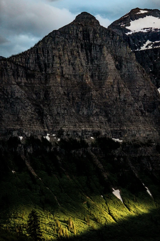 an empty field in front of a tall mountain