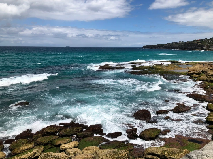 the ocean is calm and choppy on both sides