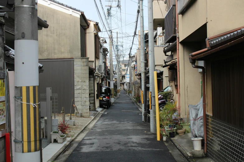 a narrow alley that's lined with buildings and a scooter