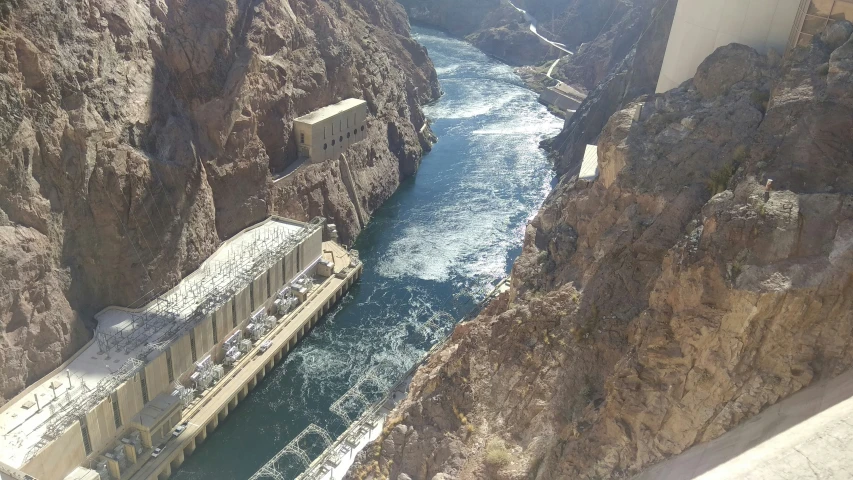 a large, high bridge over a river in a gorge